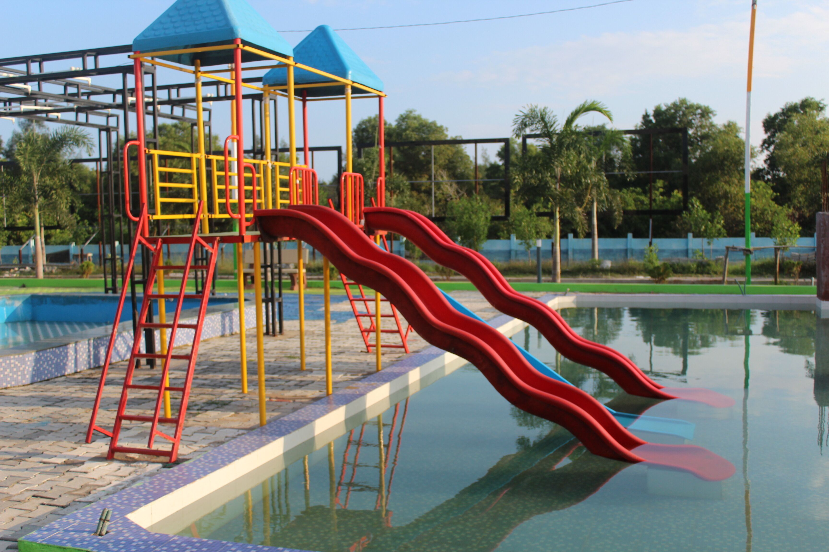 A playground with a slide and climbing structures.