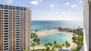 A high-rise hotel overlooking a beach with clear turquoise waters, palm trees, and a sandy shoreline. - Ocean View Waikiki Retreat at the Iconic Ilikai Hotel Near Beach and Ala Moana (Honolulu)