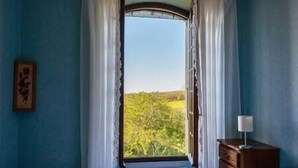 A room with a large window, curtains, a dresser, and a framed picture on the wall. - Le Clos du Prince, Country house with private pool and enclosed garden, ideal for families! (Saint-Vincent-Rive-d'Olt)