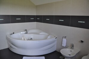 Deluxe Quadruple Room, Partial Sea View | Bathroom | Shower, hair dryer, towels, soap
