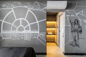A hotel room with a large wall mural, a bed, and a hallway leading to a reception area. - Copan 203e in S o Paulo (São Paulo)