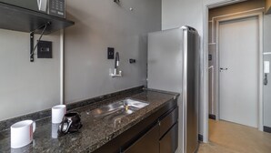 A modern kitchen with a stainless steel refrigerator, a built-in oven, and a granite countertop. - Copan 203e in S o Paulo (São Paulo)