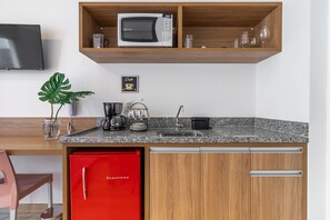 A modern kitchen with a microwave, coffee machine, and a red refrigerator. - Miq277-1107 in S o Paulo (São Paulo)