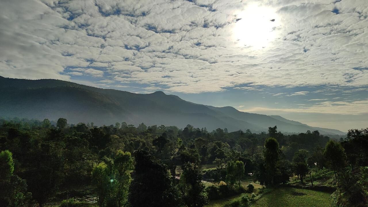 A mountainous landscape with a clear sky and sunlight.