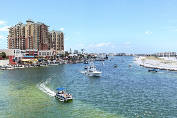 A marina with boats, a large hotel, and a beach.