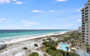 A beach resort with a pool, beach, and ocean view.