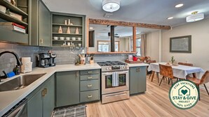 A modern kitchen with a gas stove, a coffee maker, and a sink. - Flagstaff Forest Retreat • Hot Tub • Fire Pit • Fully Fenced Yard • P... (Flagstaff)