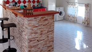 A kitchen with a central island, a washing machine, and a red and white tiled backsplash. - Top of Villa LA FLEUR DE CANNE (Lamentin)