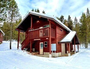 A red log cabin with a porch, a visible door, and a mailbox. - Trailer Parking- Dogs Welcome-Play and Fun (Island Park)