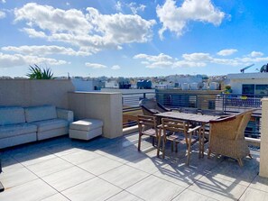 A rooftop terrace with a sofa, chairs, and a table. - Spacious 3 Double bedroom PENTHOUSE closed to Paceville and St. George Beach (Is-Swieqi)