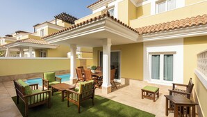 A residential building with a covered patio area featuring outdoor furniture and a swimming pool. - Home2Book Luxury Villa Pool & Terrace, Corralejo (Corralejo)