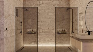A modern bathroom with stone walls, a stone floor, and a wooden ceiling.