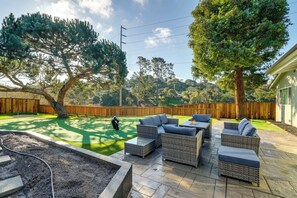 A backyard with a patio area, outdoor furniture, and a golf course. - 2 Mi to Beach: Home w/ Patio in Del Rey Oaks! (Del Rey Oaks)