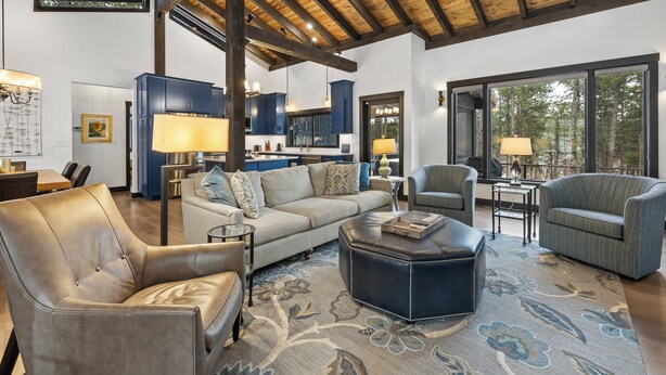 A spacious living room with a high ceiling, a sofa, two armchairs, a coffee table, and a rug. - Luxury home near Mt Rushmore!  King beds in 3 of 4 bedrooms!  (Keystone)