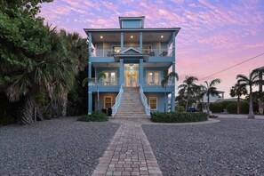 A two-story building with a central staircase, balconies, and a driveway leading to the entrance. - Blue Horizon (Fort Myers Beach)