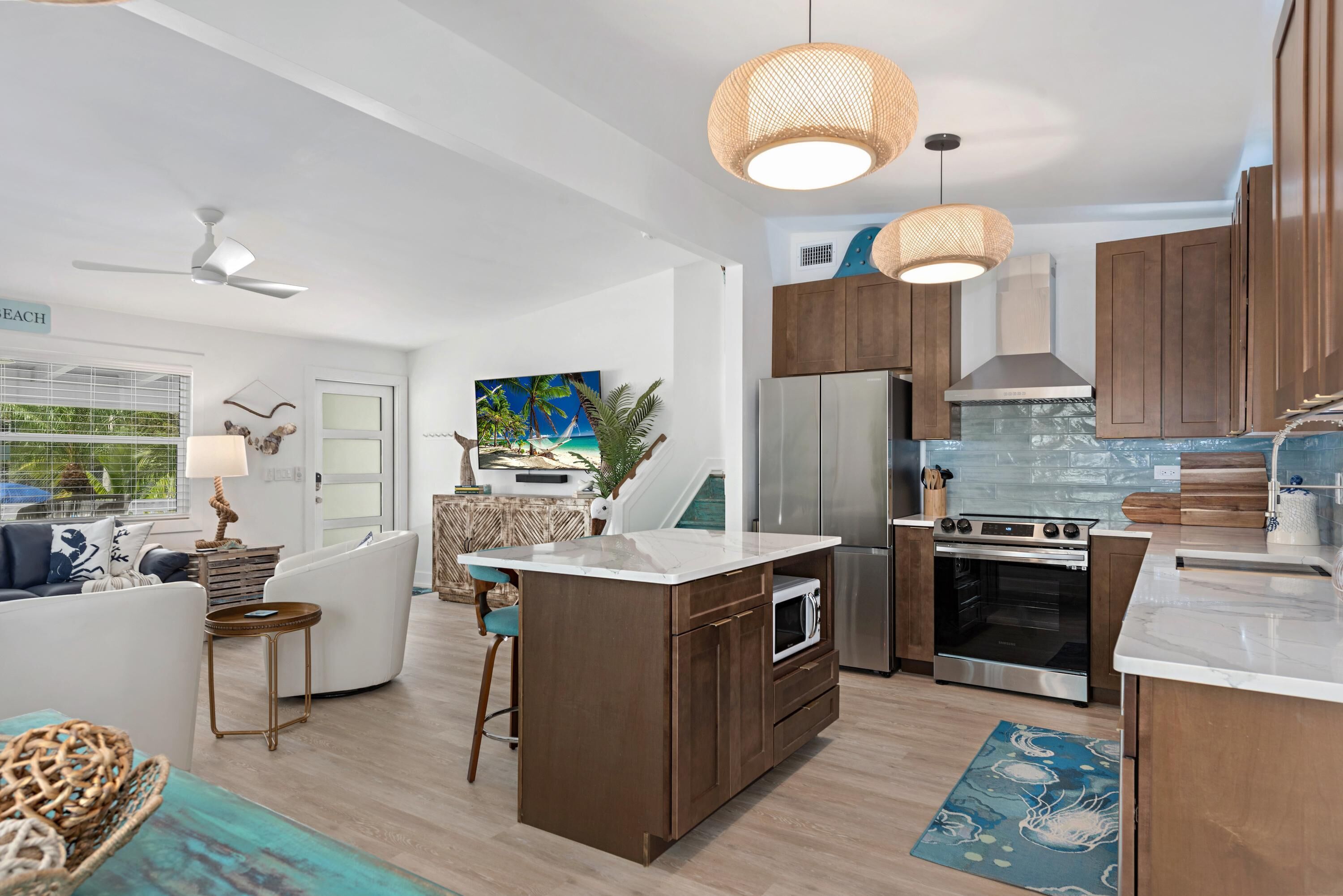 A modern kitchen with wooden cabinets, stainless steel appliances, and a central island.