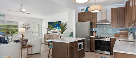 A modern kitchen with wooden cabinets, stainless steel appliances, and a central island.