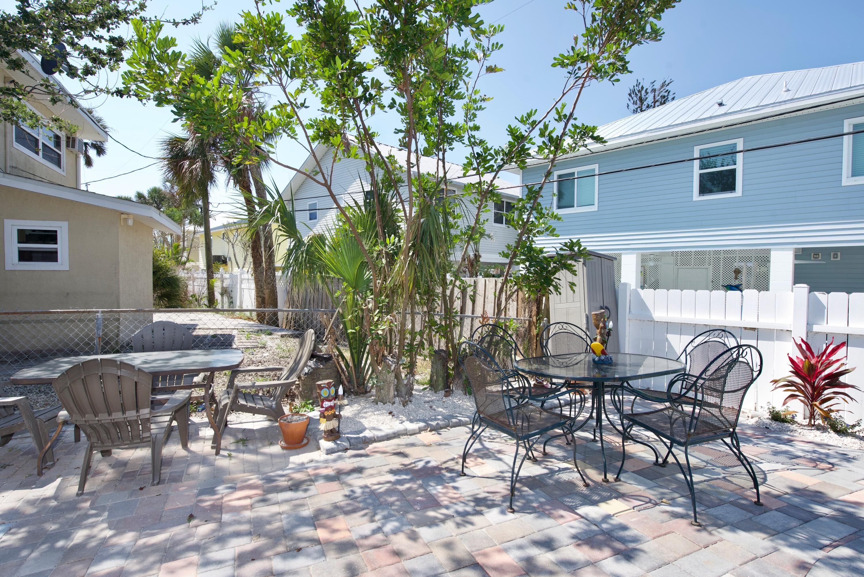 A patio with outdoor furniture, a table, and chairs.
