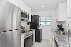 Enjoy cooking in this well-equipped kitchen with a refrigerator, oven, microwave, and dishwasher.