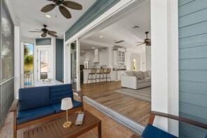 A modern living space with a sofa, a coffee table, and a ceiling fan.