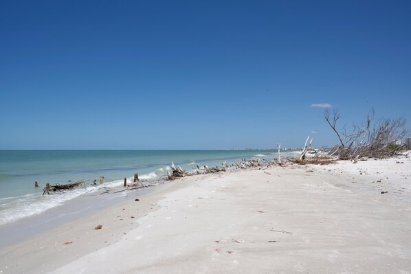 Enjoy a tranquil beach experience with calm seas and a serene atmosphere.