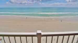 A beach view with a clear sky and calm sea. - Ponce de Leon Towers 702 (New Smyrna Beach)
