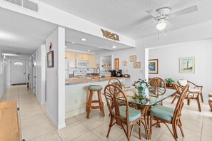 A modern kitchen with white cabinets, a microwave, and a coffee maker. - Smyrna Beach Club 607a (New Smyrna Beach)