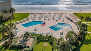 A resort with two swimming pools, a beach, and a view of the ocean. - Errol by the Sea 515 (New Smyrna Beach)