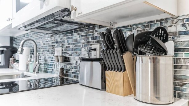 A modern kitchen with a stainless steel toaster, a knife block, and a sink. - DC Guest Suite Walkable, Parking, Pets Welcome (Washington)
