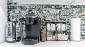 A coffee station with a Keurig machine, a glass carafe, and a coffee pot, set against a tiled backsplash. - DC Guest Suite Walkable, Parking, Pets Welcome (Washington)