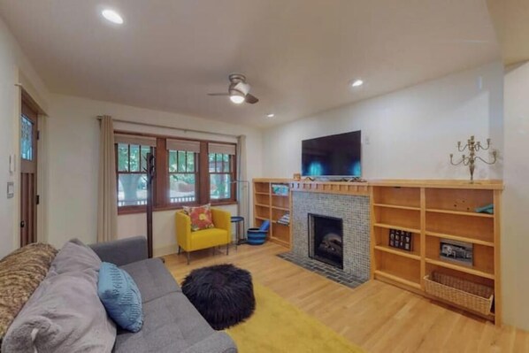 Smart TV, fireplace, books, printers