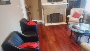A living room with a fireplace, a television, and a coffee table. - Home away from home (Vancouver)
