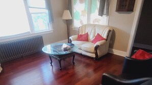 A living room with a sofa, two armchairs, a coffee table, and a radiator. - Home away from home (Vancouver)
