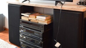 A television on a wooden stand displaying the Netflix logo and the title "Prison Break". - Siena I    (Villa Carlos Paz)