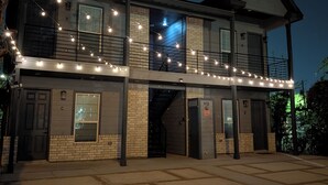Un bâtiment à deux étages doté d’un balcon et illuminé de guirlandes lumineuses.