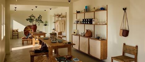 A spacious room with wooden furniture, a bookshelf, and a hanging bag.