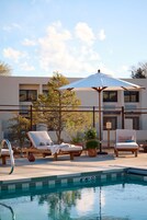 室外游泳池，提供泳池遮陽傘和日光浴躺椅