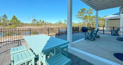 Experience luxury at 'Washed By The Water', a spacious 4-bedroom private home in Orange Beach, AL