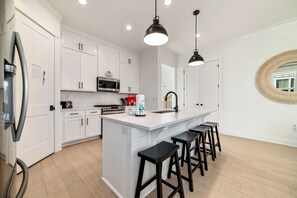 Fridge, microwave, oven, stovetop - Experience luxury at 'Washed By The Water', a spacious 4-bedroom private home in Orange Beach, AL (Orange Beach)
