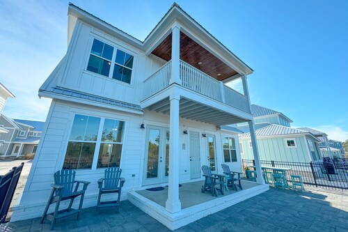 Experience luxury at 'Washed By The Water', a spacious 4-bedroom private home in Orange Beach, AL