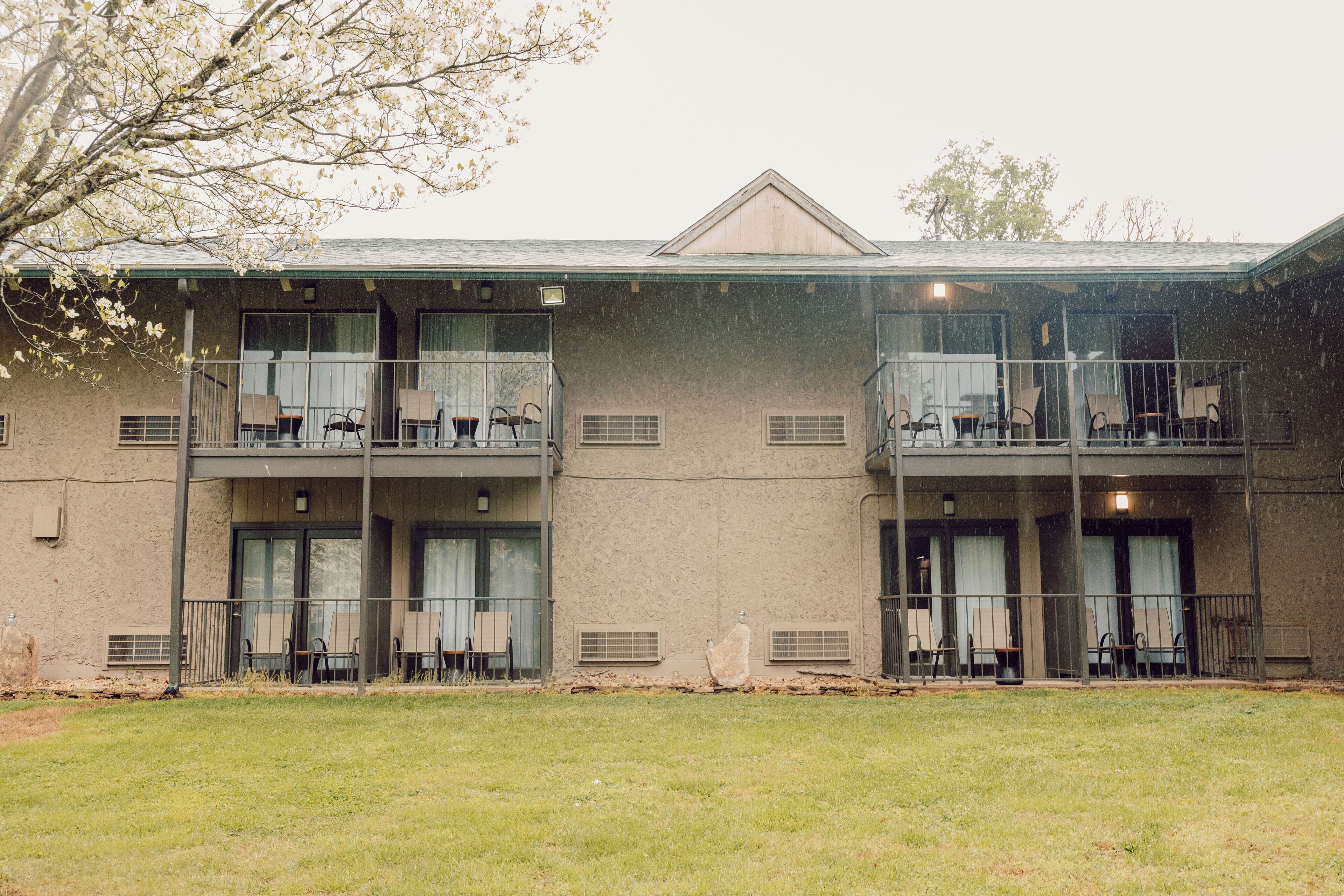 A two-story building with balconies and outdoor seating.