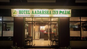 The exterior of Hotel Aadarsha Inn Pvt. Ltd. with a reception area visible through the glass doors.