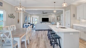 A spacious kitchen with a central island, white cabinetry, and a ceiling fan. - Touchdown Hideaway! Beach/OWA/Sports/Shopping (Foley)