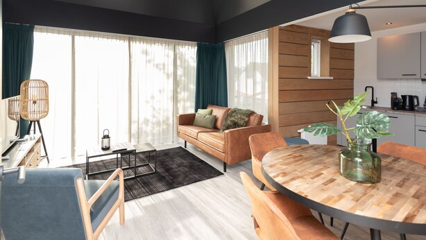 A modern living room with a sofa, coffee table, and dining area. - Renesse Bomont Sauna by Interhome (Renesse)