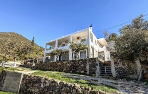 Relax on the upper-floor balcony overlooking the hilly surroundings.
