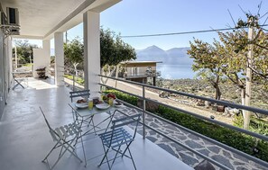 Enjoy a meal on the balcony with a view of the surrounding mountains and water.