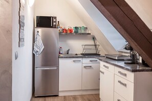 Fridge, microwave, coffee/tea maker, cookware/dishes/utensils