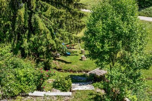 A lush green landscape with a small wooden structure, possibly a cabin, surrounded by dense trees and a clear sky. - Apartment 'Fingerhut' with Mountain View, Private Terrace and Wi-Fi (Feldberg (Schwarzwald))
