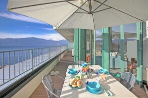 Enjoy a romantic meal on this oceanfront balcony with a stunning view of the distant mountains.