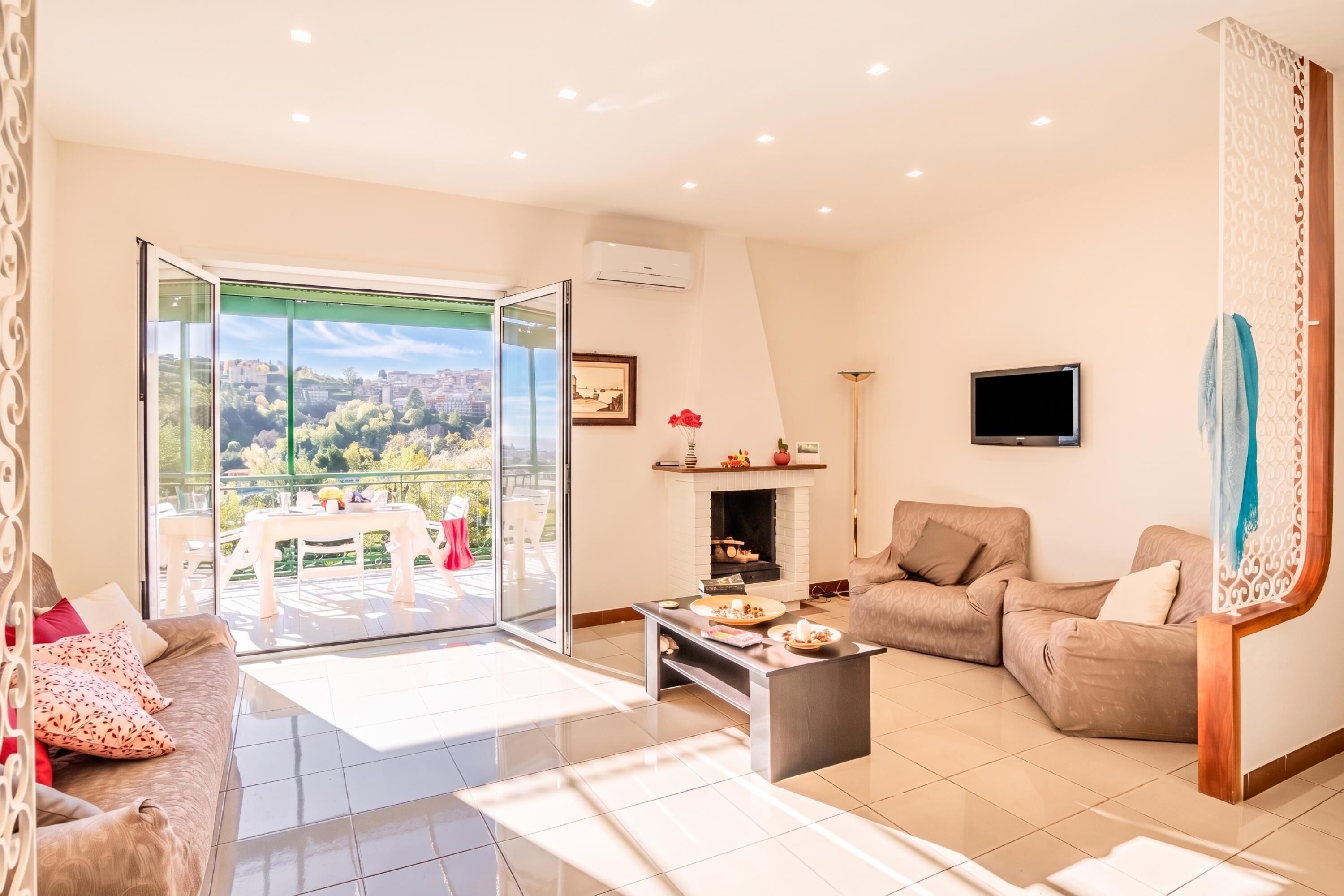A spacious living area with a sofa, coffee table, and a fireplace.